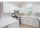 Stylish kitchen featuring white cabinetry, quartz counters and stainless steel appliances at 108 Ellsworth Pl, Cary, NC 27511