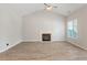 Inviting living room featuring wood flooring, a fireplace, and a large window at 108 Ellsworth Pl, Cary, NC 27511