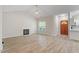 Bright living room with wood floors, fireplace, and a view of the front entrance at 108 Ellsworth Pl, Cary, NC 27511