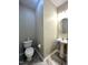 Half bathroom featuring sleek pedestal sink and hardwood-style flooring at 1100 Birkdale Dr, Mebane, NC 27302