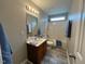 Bathroom featuring a vanity, shower-tub combo, and wood-style flooring at 1100 Birkdale Dr, Mebane, NC 27302