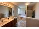 Bathroom featuring double sinks, soaking tub, shower and wood-style flooring at 1100 Birkdale Dr, Mebane, NC 27302