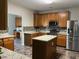 Modern kitchen with granite countertops, stainless steel appliances, mosaic backsplash and island at 1100 Birkdale Dr, Mebane, NC 27302