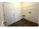 Convenient laundry room with overhead wire shelving and exterior door at 1100 Birkdale Dr, Mebane, NC 27302