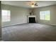 Large living room with a fireplace, neutral carpeting, and an abundance of natural light at 1100 Birkdale Dr, Mebane, NC 27302