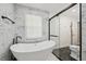 Elegant bathroom featuring a freestanding tub and black accents at 1104 Suterland Rd, Cary, NC 27511