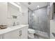 Modern bathroom with a white vanity, sleek fixtures, and a glass-enclosed shower with stylish tile work at 1104 Suterland Rd, Cary, NC 27511