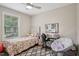 Bright bedroom features a ceiling fan, desk, and bed with floral bedding at 1104 Suterland Rd, Cary, NC 27511