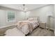 Cozy bedroom boasts a neutral palette and ample natural light from the window at 1104 Suterland Rd, Cary, NC 27511