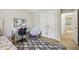 Bedroom with white closet doors, grey rug, study desk and chair at 1104 Suterland Rd, Cary, NC 27511