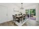 Dining area with modern lighting and sliding glass doors leading to deck at 1104 Suterland Rd, Cary, NC 27511