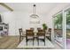Dining room featuring stylish light fixture and sliding glass doors to the deck at 1104 Suterland Rd, Cary, NC 27511