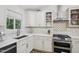 A stylish kitchen showcases white cabinets, quartz countertops, stainless steel appliances, and modern fixtures at 1104 Suterland Rd, Cary, NC 27511