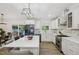A beautifully updated kitchen features white cabinets, quartz counters, stainless appliances, and an open layout at 1104 Suterland Rd, Cary, NC 27511