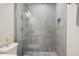 Contemporary bathroom featuring a glass shower with gray tiling and modern fixtures at 1104 Suterland Rd, Cary, NC 27511