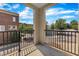 Balcony with black metal railings offering an exterior view of nearby buildings and trees at 117 Finsbury St, Durham, NC 27703