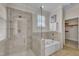 Elegant bathroom with a walk-in glass shower, soaking tub, and natural light at 117 Finsbury St, Durham, NC 27703