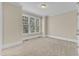 Bedroom with large windows, carpet, and neutral paint ready for personalization at 117 Finsbury St, Durham, NC 27703