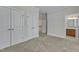 Spacious bedroom with carpet, white closet doors, and an ensuite bathroom at 117 Finsbury St, Durham, NC 27703
