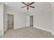 Bedroom with a ceiling fan, carpet, and an ensuite bathroom with a tiled shower at 117 Finsbury St, Durham, NC 27703