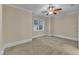 Bedroom featuring a ceiling fan, neutral carpeting, trim, and walls, as well as a window at 117 Finsbury St, Durham, NC 27703