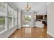 Bright dining area with hardwood floors, balcony access, and an open flow to the kitchen space at 117 Finsbury St, Durham, NC 27703