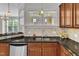 Spacious kitchen with granite countertops, stainless steel appliances, and a view of the backyard at 117 Finsbury St, Durham, NC 27703