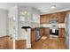 Updated kitchen with stainless steel appliances, granite countertops, and wooden cabinets at 117 Finsbury St, Durham, NC 27703