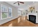 Spacious living room featuring hardwood floors and large windows, ideal for entertaining at 117 Finsbury St, Durham, NC 27703