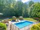 Aerial view of the fenced in pool and landscaped backyard at 1209 Ravens Point Cir, Raleigh, NC 27614