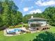 Expansive backyard featuring a swimming pool, hot tub, and a spacious deck at 1209 Ravens Point Cir, Raleigh, NC 27614