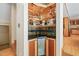 Custom home bar with stylish backsplash, mini-fridge, and custom shelving for bottles at 1209 Ravens Point Cir, Raleigh, NC 27614