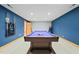Finished basement area featuring a pool table with new carpet flooring and light blue accent walls at 1209 Ravens Point Cir, Raleigh, NC 27614