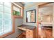 Bright bathroom vanity area features a granite countertop, and natural wood trim with a view to the main bedroom at 1209 Ravens Point Cir, Raleigh, NC 27614