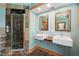 Stylish bathroom featuring double sinks, unique tile work, and a glass-enclosed shower for a spa-like feel at 1209 Ravens Point Cir, Raleigh, NC 27614