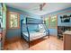 Stylish bedroom featuring a fun bunk bed, built-in shelves, and plenty of natural light from two windows at 1209 Ravens Point Cir, Raleigh, NC 27614