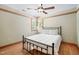 Bright bedroom with a ceiling fan and hardwood floors offers a cozy retreat for relaxation and rest at 1209 Ravens Point Cir, Raleigh, NC 27614