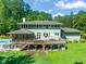A lush backyard with a spacious deck, screened-in porch and expansive lawn at 1209 Ravens Point Cir, Raleigh, NC 27614