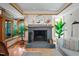 Elegant fireplace with stone hearth and wooden mantle in a naturally lit living room at 1209 Ravens Point Cir, Raleigh, NC 27614