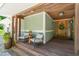 Inviting covered front porch with seating area and natural wood accents at 1209 Ravens Point Cir, Raleigh, NC 27614