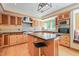Well-appointed kitchen with stainless steel appliances, a black granite island and wood cabinetry at 1209 Ravens Point Cir, Raleigh, NC 27614