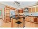 Spacious kitchen featuring custom wood cabinetry and a black granite island at 1209 Ravens Point Cir, Raleigh, NC 27614