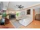 Cozy living room featuring a fireplace, ceiling fan, and comfortable sectional couch at 1209 Ravens Point Cir, Raleigh, NC 27614