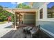 Covered patio with wooden bench and table to enjoy the outdoors at 1209 Ravens Point Cir, Raleigh, NC 27614