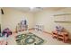 A playroom with shelving, carpet and a colorful race car rug at 1209 Ravens Point Cir, Raleigh, NC 27614