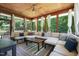 Spacious screened-in porch featuring a ceiling fan, wood flooring and cozy seating for guests at 1209 Ravens Point Cir, Raleigh, NC 27614