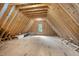 Unfinished attic space with wood rafters and a window at 1212 Gunnison Pl, Raleigh, NC 27609