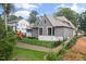 Exterior view of a large home with a playhouse and a fenced yard at 1212 Gunnison Pl, Raleigh, NC 27609
