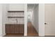 Stylish bar area with custom cabinets, granite countertop, backsplash, and shelving at 1212 Gunnison Pl, Raleigh, NC 27609