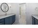 Stylish bathroom with patterned tile floor and blue vanity at 1212 Gunnison Pl, Raleigh, NC 27609